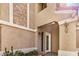 Stucco exterior detailing the front entryway with a white door and desert plants at 529 E Taro Ln, Phoenix, AZ 85024