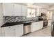 Modern kitchen with white cabinets, stainless steel appliances, stylish backsplash and sink at 529 E Taro Ln, Phoenix, AZ 85024