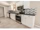 Modern kitchen with white cabinets, stainless steel appliances, and stylish backsplash at 529 E Taro Ln, Phoenix, AZ 85024