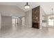 Large living room with tiled floors, a modern fireplace, and neutral paint, open layout at 529 E Taro Ln, Phoenix, AZ 85024
