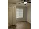 Bedroom featuring closet doors, wood-look floors, a ceiling fan, and a window with blinds at 540 E Royal Palms Dr, Mesa, AZ 85203
