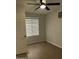 Bedroom area featuring wood-look floors, a ceiling fan, and a window with blinds at 540 E Royal Palms Dr, Mesa, AZ 85203
