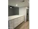 Renovated kitchen with island, quartz countertops, stainless steel appliances, and white cabinets at 540 E Royal Palms Dr, Mesa, AZ 85203