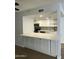 Modern kitchen features white cabinets, quartz countertops, stainless appliances, and tile backsplash at 540 E Royal Palms Dr, Mesa, AZ 85203