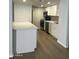 Updated kitchen features sleek stainless steel appliances, quartz countertops, and crisp white cabinetry at 540 E Royal Palms Dr, Mesa, AZ 85203