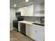 Close up of remodeled kitchen features stainless appliances, white cabinetry, and quartz countertops at 540 E Royal Palms Dr, Mesa, AZ 85203