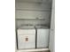 A well-lit laundry area with a white washer and dryer set, and white shelving for additional storage at 540 E Royal Palms Dr, Mesa, AZ 85203