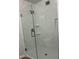 Updated shower featuring white marble-look walls, built in storage shelves, and a clear glass enclosure at 540 E Royal Palms Dr, Mesa, AZ 85203
