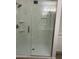 Updated shower featuring white marble-look walls, built in storage shelves, and a clear glass enclosure at 540 E Royal Palms Dr, Mesa, AZ 85203