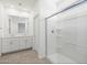 Clean and modern bathroom with double vanity and glass-enclosed shower stall at 5549 S 246Th Ave, Buckeye, AZ 85326