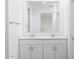 Bright bathroom features a double vanity with white cabinets and an expansive mirror at 5549 S 246Th Ave, Buckeye, AZ 85326