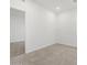 Bright bedroom with modern tile flooring and neutral color palette, ready for personalization at 5549 S 246Th Ave, Buckeye, AZ 85326