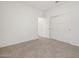 A carpeted bedroom features a closet with sliding doors and an adjoining doorway at 5549 S 246Th Ave, Buckeye, AZ 85326