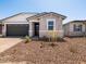 Charming single-story home with a dark garage door and simple desert landscaping at 5549 S 246Th Ave, Buckeye, AZ 85326