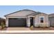 Charming single-story home featuring a dark garage door and decorative stone accents at 5549 S 246Th Ave, Buckeye, AZ 85326