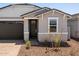 Welcoming front entrance with dark wood door, light brick accents, and minimal landscaping at 5549 S 246Th Ave, Buckeye, AZ 85326