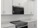 Close-up of the modern kitchen with white cabinets and stainless steel appliances at 5549 S 246Th Ave, Buckeye, AZ 85326