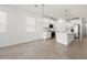 Open kitchen boasts white cabinets, stainless steel appliances, and a center island at 5549 S 246Th Ave, Buckeye, AZ 85326