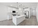Modern kitchen featuring white cabinets, stainless steel appliances, and a spacious center island at 5549 S 246Th Ave, Buckeye, AZ 85326