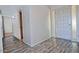 Light-filled entryway with wood-look floors leads to various parts of the house at 5932 E Colby St, Mesa, AZ 85205