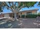 Charming home with a well-maintained front yard and mature shade trees at 5932 E Colby St, Mesa, AZ 85205