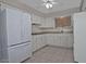 Bright kitchen featuring white cabinetry, tile backsplash, and modern appliances including a large refrigerator at 5932 E Colby St, Mesa, AZ 85205