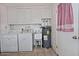 Functional laundry area with appliances and overhead cabinets for organized storage solutions at 5932 E Colby St, Mesa, AZ 85205