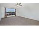 Spacious living room with neutral carpet, large window, and neutral walls at 5932 E Colby St, Mesa, AZ 85205