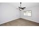 The bedroom is well lit with neutral walls and carpet and a ceiling fan at 6504 W Cochise Dr, Glendale, AZ 85302
