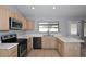 Spacious kitchen with stainless steel appliances and ample counter space at 6504 W Cochise Dr, Glendale, AZ 85302