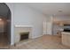 Inviting living room with tile flooring, fireplace, and open access to kitchen at 6504 W Cochise Dr, Glendale, AZ 85302