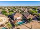 An aerial view of a home featuring a fenced pool, covered patio, and desert landscaping in a neighborhood at 654 E Taylor Trl, San Tan Valley, AZ 85143