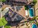 Aerial view of home with tile roof, solar panels, pool, patio, and fenced backyard with green grass area at 654 E Taylor Trl, San Tan Valley, AZ 85143