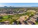 Aerial view of a house near a desert golf course and mountains at 654 E Taylor Trl, San Tan Valley, AZ 85143