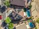 Aerial view of a home with solar panels, a pool, patio area, driveway, and desert landscaping at 654 E Taylor Trl, San Tan Valley, AZ 85143