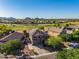 Expansive aerial view of a community featuring a golf course and panoramic desert mountain vistas at 654 E Taylor Trl, San Tan Valley, AZ 85143