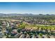 Wide aerial shot of a neighborhood next to an attractive golf course, against a mountain backdrop at 654 E Taylor Trl, San Tan Valley, AZ 85143
