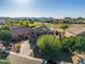 Lovely aerial view of house with lush landscaping and desert mountains in the background at 654 E Taylor Trl, San Tan Valley, AZ 85143