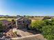 Stunning aerial view of a home with a tile roof, golf course views, and a well-manicured yard at 654 E Taylor Trl, San Tan Valley, AZ 85143