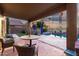 View of covered back patio with seating and a table by the pool with privacy fence at 654 E Taylor Trl, San Tan Valley, AZ 85143
