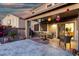 Paver patio with seating and grill, festive decorations, and sliding door at 654 E Taylor Trl, San Tan Valley, AZ 85143