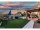 Backyard with a pool, artificial turf, and covered patio at 654 E Taylor Trl, San Tan Valley, AZ 85143