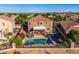 A backyard featuring a fenced pool, covered patio, desert landscaping, and partial view of the home at 654 E Taylor Trl, San Tan Valley, AZ 85143