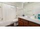 Bright bathroom with a shower-tub combo, and wood-look floors at 654 E Taylor Trl, San Tan Valley, AZ 85143