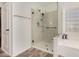 Walk-in shower in the bathroom of this home with built-in shelving and glass door at 654 E Taylor Trl, San Tan Valley, AZ 85143