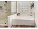 Bathroom with a soaking tub, glass block window, and a glass enclosed shower at 654 E Taylor Trl, San Tan Valley, AZ 85143