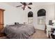 Comfortable bedroom with carpet flooring, ceiling fan and arched windows at 654 E Taylor Trl, San Tan Valley, AZ 85143