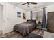 Cozy bedroom features wood-look flooring, a ceiling fan, and natural light from the window at 654 E Taylor Trl, San Tan Valley, AZ 85143
