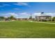 Expansive community park with lush lawn, gazebos, and playground under a clear blue sky at 654 E Taylor Trl, San Tan Valley, AZ 85143