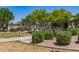 Community pool area featuring manicured landscaping and a glimpse of the inviting pool at 654 E Taylor Trl, San Tan Valley, AZ 85143